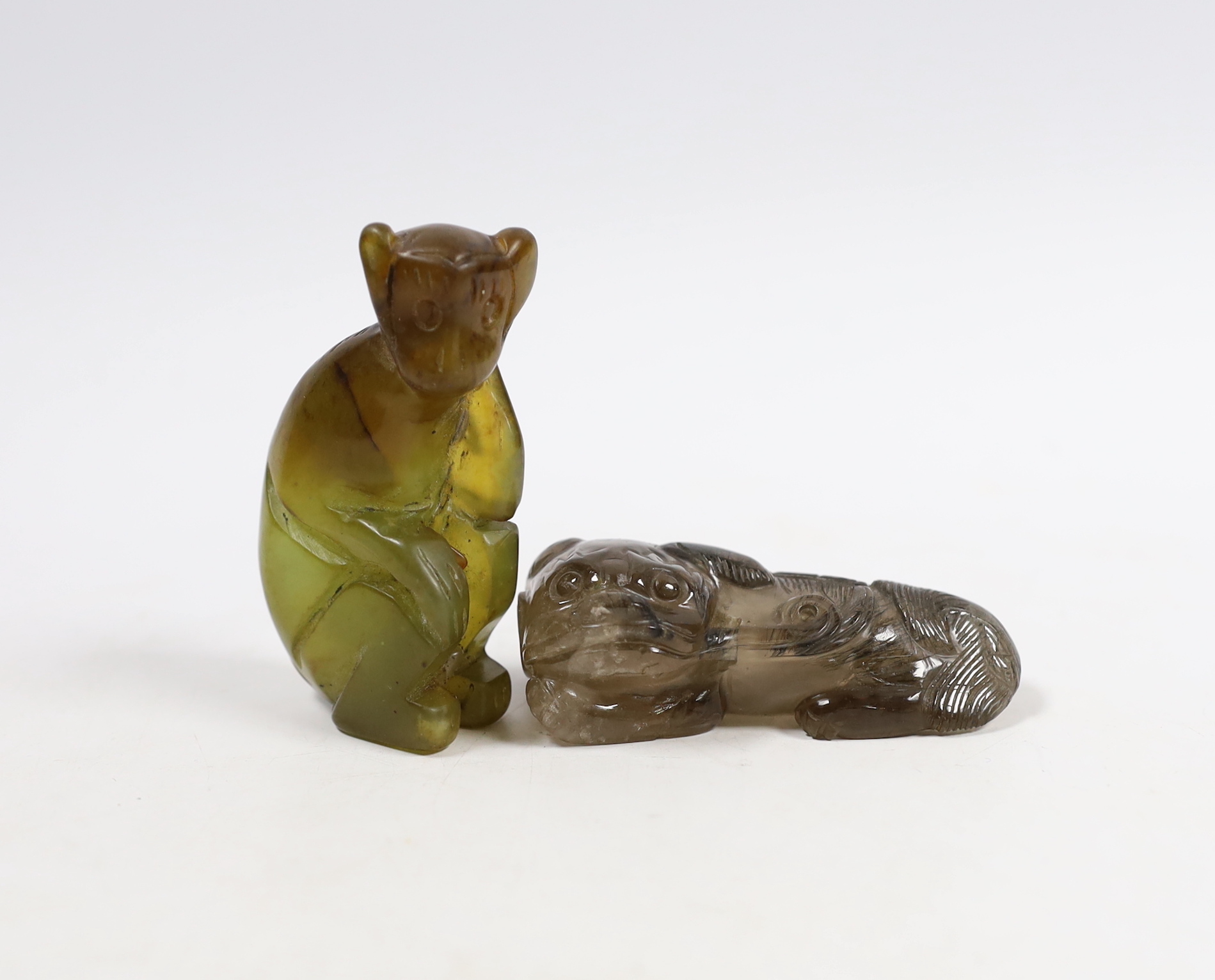 A Chinese smokey quartz lion scent bottle and a carved bowenite model of a monkey, longest 7.5cm